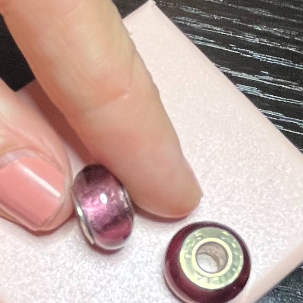Pair of purple glass Chamilia charm beads